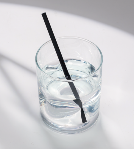 6-inch Black Cocktail hemp straw in a short glass of water